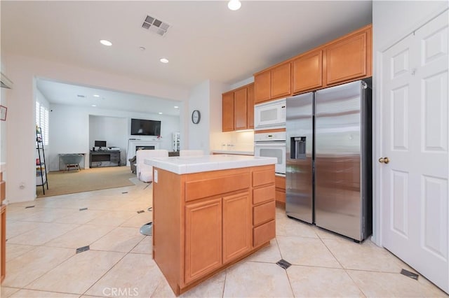 15752 Mimosa Ct, Fontana, CA 92336 - kitchen featuring white appliances, tile counters, a fireplace, light tile patterned floors, and recessed lighting