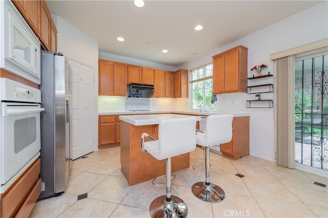 15752 Mimosa Ct, Fontana, CA 92336 - kitchen with white appliances, light countertops, recessed lighting, tasteful backsplash, and a center island