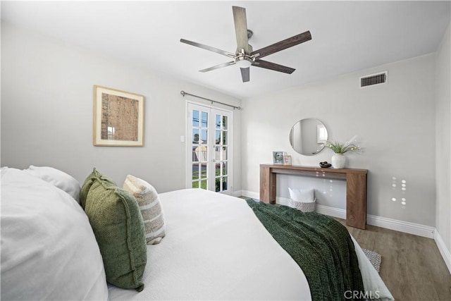 bedroom featuring wood finished floors, baseboards, and ceiling fan