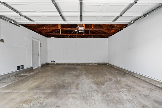 garage with baseboards and a garage door opener