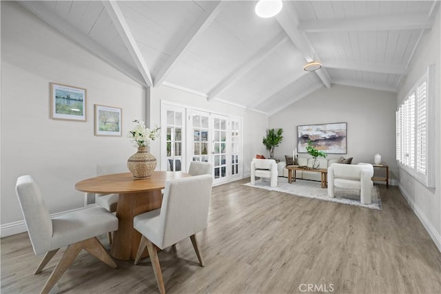 dining room with french doors, light wood-style floors, and baseboards