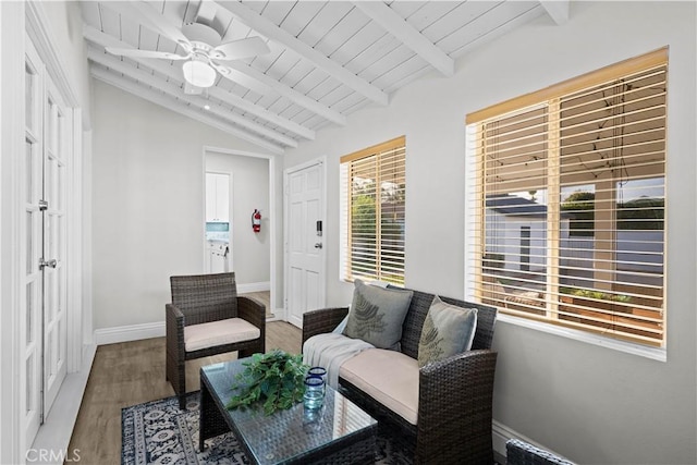 living area with wood finished floors, a ceiling fan, baseboards, and wooden ceiling