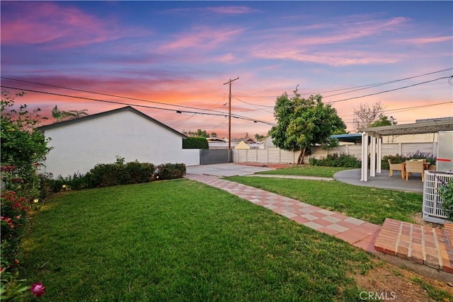 yard at dusk featuring central air condition unit, a patio area, an outdoor hangout area, and a pergola