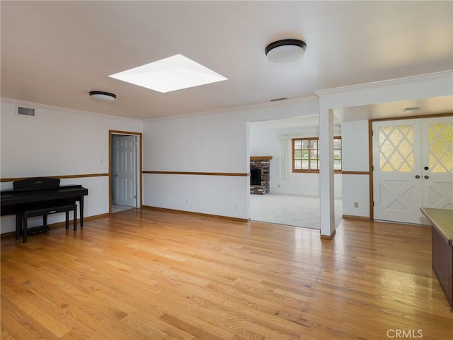 1715 W Santa Cruz St, San Pedro, CA 90732 - living area featuring a skylight, light wood finished floors, ornamental molding, a fireplace, and baseboards
