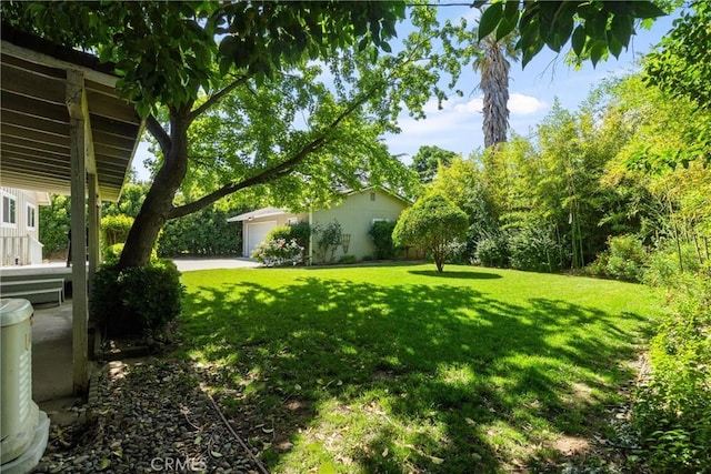 253 Gurnsey Dr, Red Bluff, CA 96080 - view of grassy yard featuring an attached garage and driveway