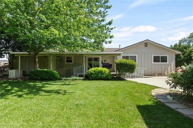 253 Gurnsey Dr, Red Bluff, CA 96080 - view of front of property featuring board and batten siding, a front lawn, and a porch