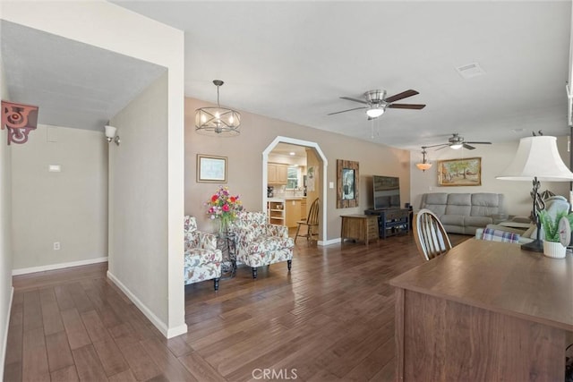 253 Gurnsey Dr, Red Bluff, CA 96080 - dining area with dark wood-style flooring, a ceiling fan, baseboards, and arched walkways
