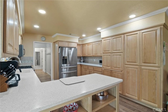 253 Gurnsey Dr, Red Bluff, CA 96080 - kitchen featuring stainless steel appliances, crown molding, a peninsula, light countertops, and light brown cabinets
