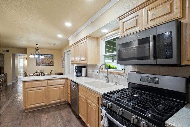 253 Gurnsey Dr, Red Bluff, CA 96080 - kitchen with stainless steel appliances, a sink, a peninsula, a chandelier, and light countertops