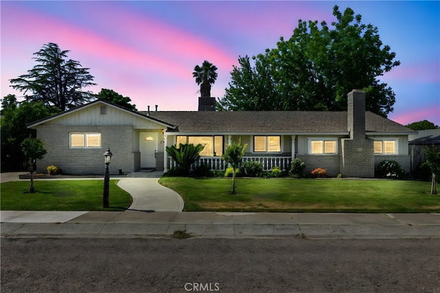 253 Gurnsey Dr, Red Bluff, CA 96080 - ranch-style home featuring brick siding, a chimney, and a lawn