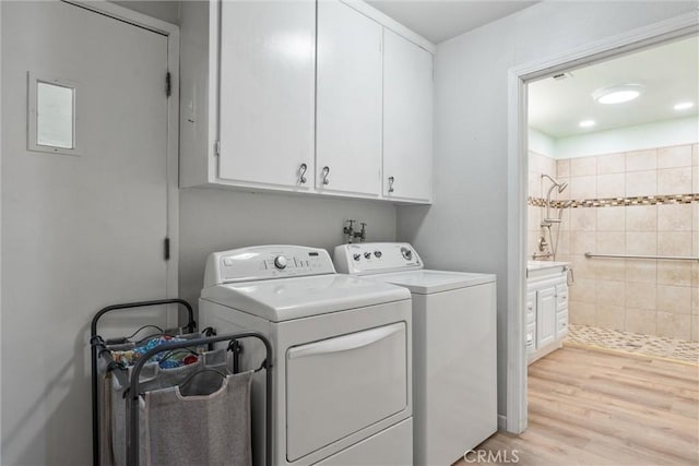 253 Gurnsey Dr, Red Bluff, CA 96080 - washroom featuring cabinet space, independent washer and dryer, and light wood-type flooring