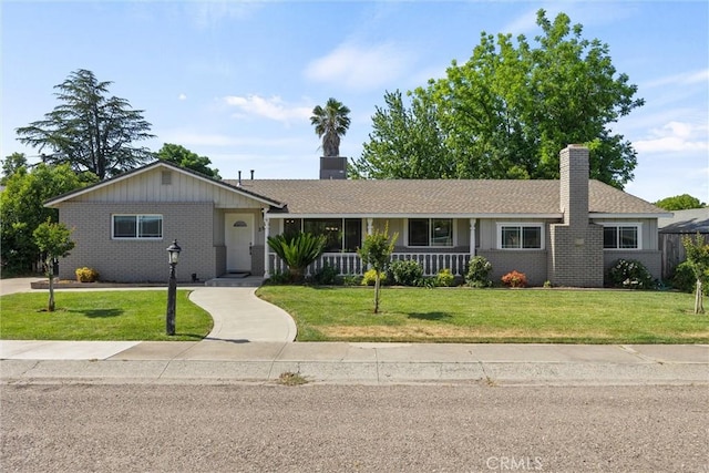 253 Gurnsey Dr, Red Bluff, CA 96080 - ranch-style house with brick siding, a chimney, a front yard, and covered porch