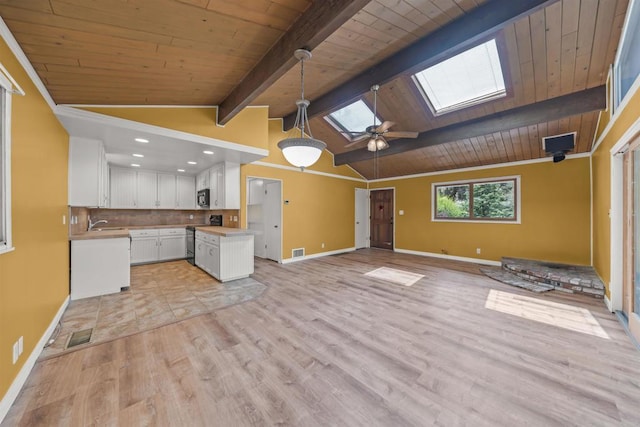 29131 Half Moon Trl, Pine Valley, CA 91962 - kitchen featuring open floor plan, a skylight, wooden ceiling, white cabinetry, and baseboards