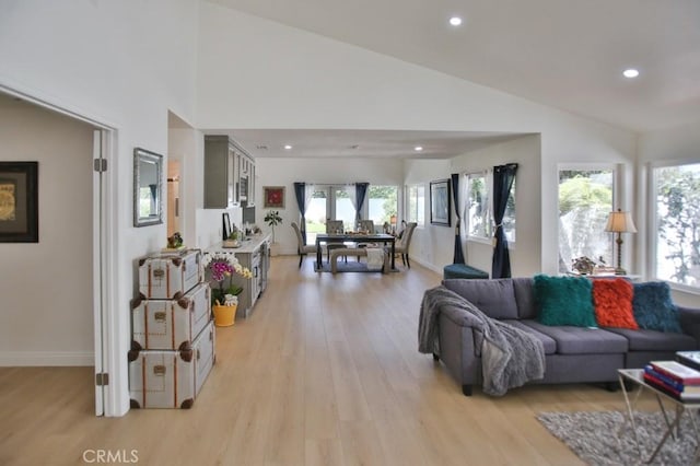 17041 Malta Cir, Huntington Beach, CA 92649 - living area with light wood-style floors, vaulted ceiling, healthy amount of natural light, recessed lighting, and baseboards
