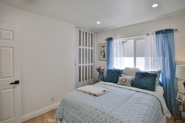 17041 Malta Cir, Huntington Beach, CA 92649 - bedroom with light wood-style flooring, recessed lighting, and baseboards