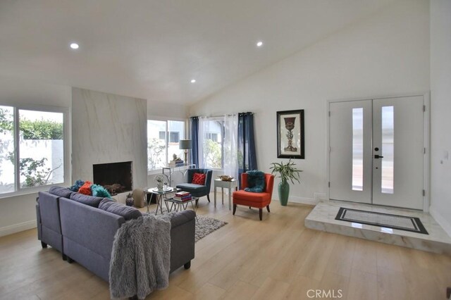 17041 Malta Cir, Huntington Beach, CA 92649 - living area featuring recessed lighting, baseboards, light wood finished floors, a fireplace, and high vaulted ceiling