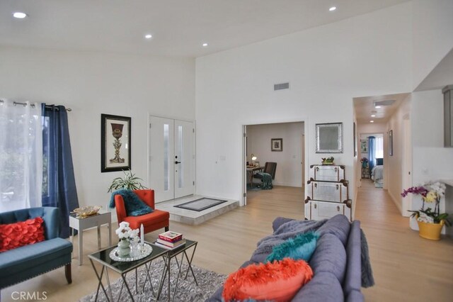 17041 Malta Cir, Huntington Beach, CA 92649 - living area with light wood-style flooring, high vaulted ceiling, recessed lighting, and french doors