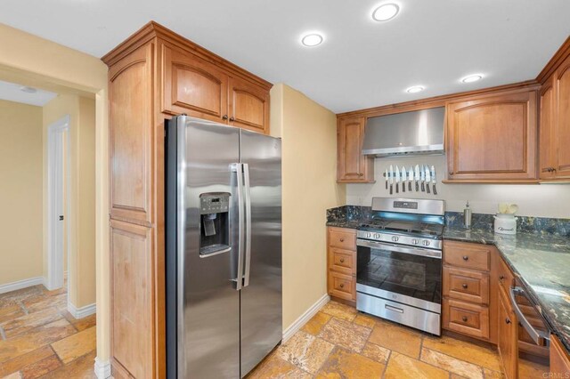 515 S Sierra Ave Unit 130, Solana Beach, CA 92075 - kitchen featuring appliances with stainless steel finishes, wall chimney exhaust hood, stone tile floors, baseboards, and recessed lighting