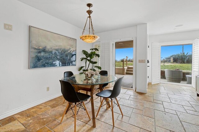 515 S Sierra Ave Unit 130, Solana Beach, CA 92075 - dining space with stone tile floors and baseboards