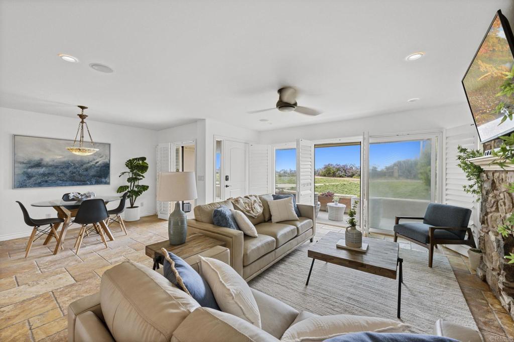 515 S Sierra Ave Unit 130, Solana Beach, CA 92075 - living area with stone tile flooring, baseboards, ceiling fan, and recessed lighting