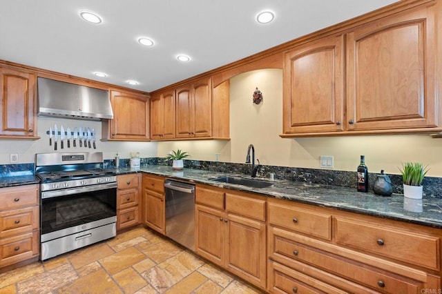 515 S Sierra Ave Unit 130, Solana Beach, CA 92075 - kitchen with stainless steel appliances, wall chimney exhaust hood, a sink, stone tile flooring, and dark stone counters