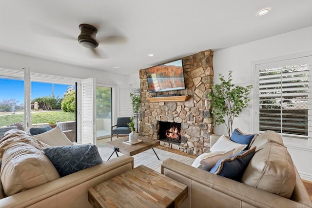 515 S Sierra Ave Unit 130, Solana Beach, CA 92075 - living area featuring ceiling fan, a stone fireplace, and wood finished floors