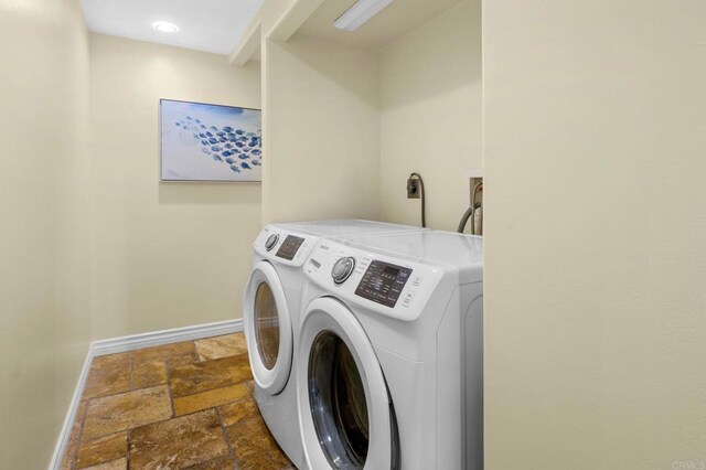 515 S Sierra Ave Unit 130, Solana Beach, CA 92075 - laundry area with baseboards, stone tile floors, and separate washer and dryer