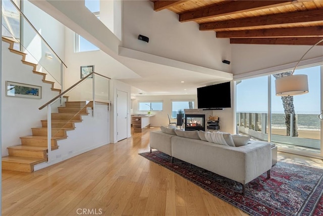 7335 Vista Del Mar Ln, Playa Del Rey, CA 90293 - living room with wood ceiling, stairway, beam ceiling, light wood-style floors, and a multi sided fireplace