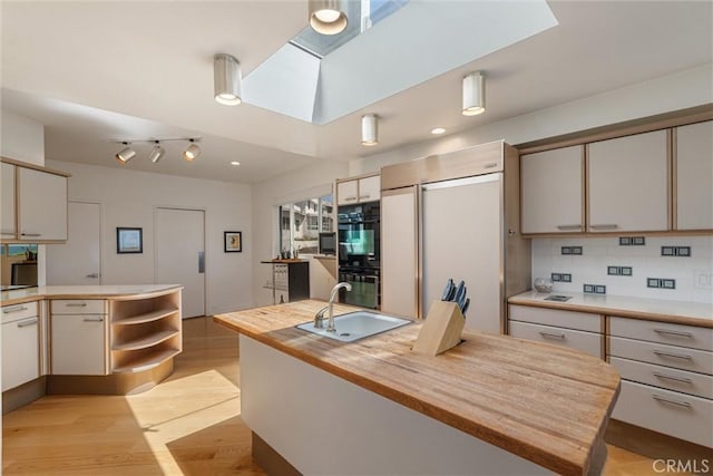 7335 Vista Del Mar Ln, Playa Del Rey, CA 90293 - kitchen featuring a sink, wooden counters, built in refrigerator, light wood finished floors, and tasteful backsplash