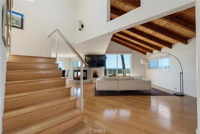 7335 Vista Del Mar Ln, Playa Del Rey, CA 90293 - living area featuring wood ceiling, stairway, a multi sided fireplace, wood finished floors, and baseboards