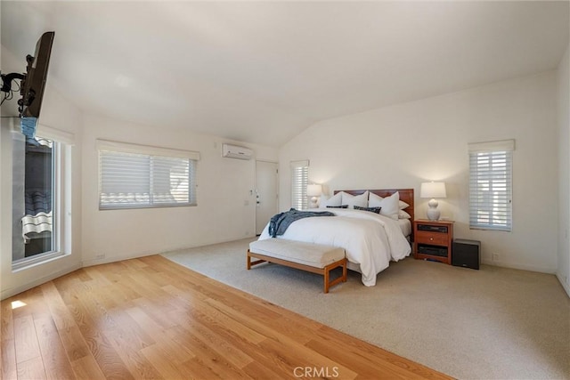 7335 Vista Del Mar Ln, Playa Del Rey, CA 90293 - bedroom featuring a wall unit AC, lofted ceiling, and wood finished floors