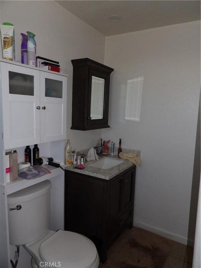 half bathroom featuring toilet and vanity