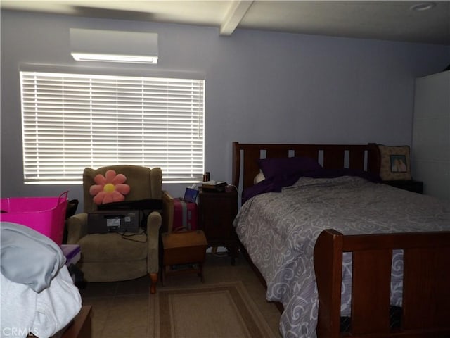 bedroom featuring multiple windows and beam ceiling