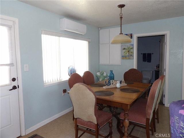 dining room featuring an AC wall unit, plenty of natural light, and light tile patterned flooring