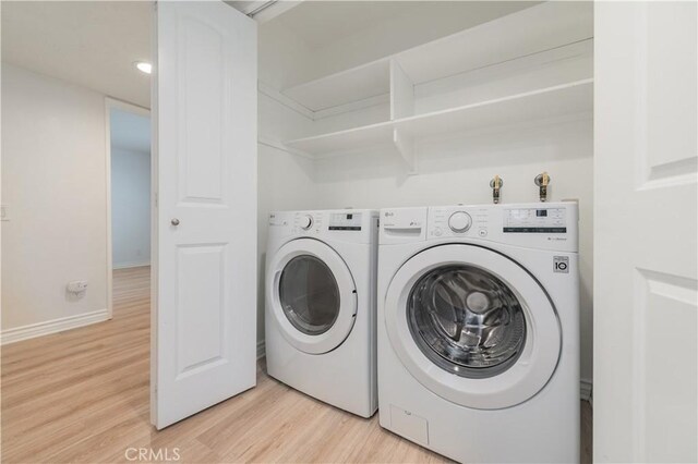 61 Greenfield Unit 68, Irvine, CA 92614 - laundry room featuring light wood-style floors, washing machine and dryer, and baseboards