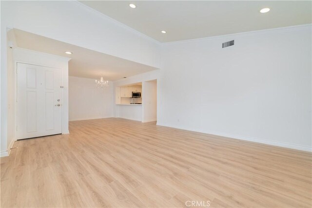 61 Greenfield Unit 68, Irvine, CA 92614 - unfurnished living room featuring crown molding, a chandelier, light wood-style floors, recessed lighting, and baseboards
