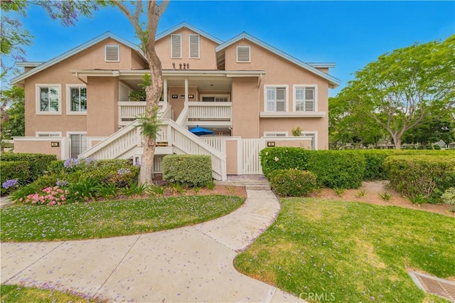61 Greenfield Unit 68, Irvine, CA 92614 - multi unit property featuring stairway, stucco siding, a porch, and a front yard