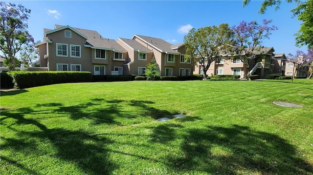61 Greenfield Unit 68, Irvine, CA 92614 - surrounding community featuring a residential view and a lawn