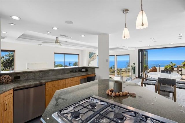 31532 Valido Rd, Laguna Beach, CA 92651 - kitchen with stainless steel appliances, recessed lighting, brown cabinets, dark stone countertops, and a tray ceiling