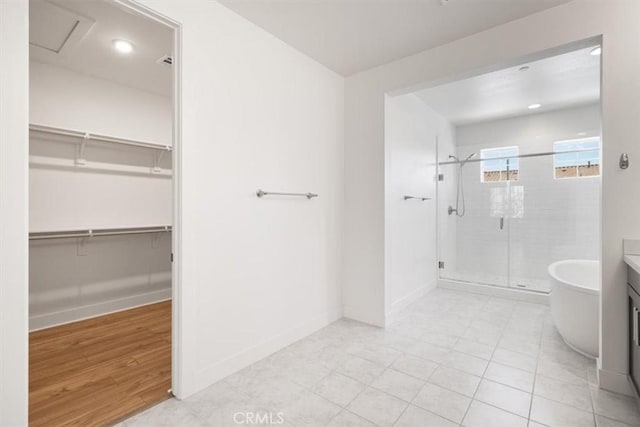 1901 Aliso Canyon Dr, Lake Forest, CA 92610 - bathroom with a stall shower, a walk in closet, baseboards, vanity, and recessed lighting