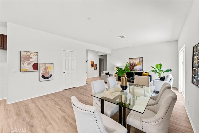 dining room with light wood finished floors and baseboards
