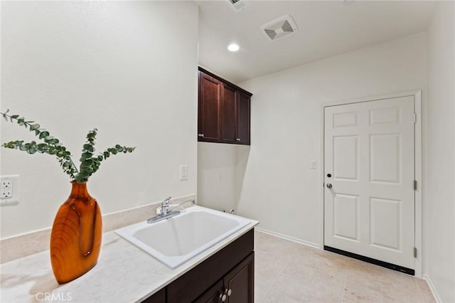 washroom with a sink and baseboards