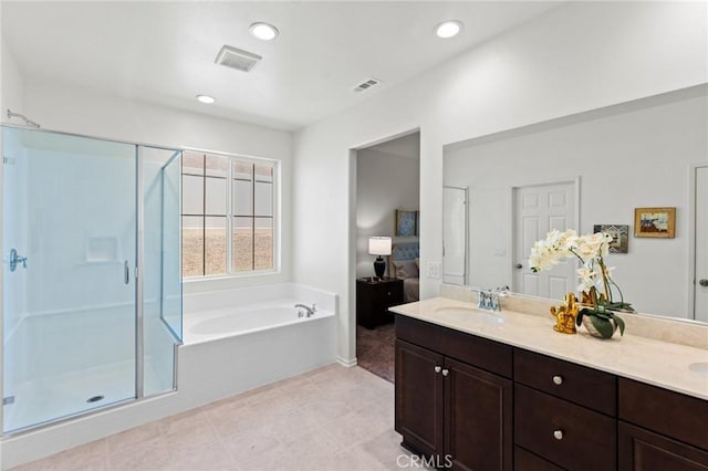 bathroom with a stall shower, a bath, double vanity, recessed lighting, and tile patterned flooring