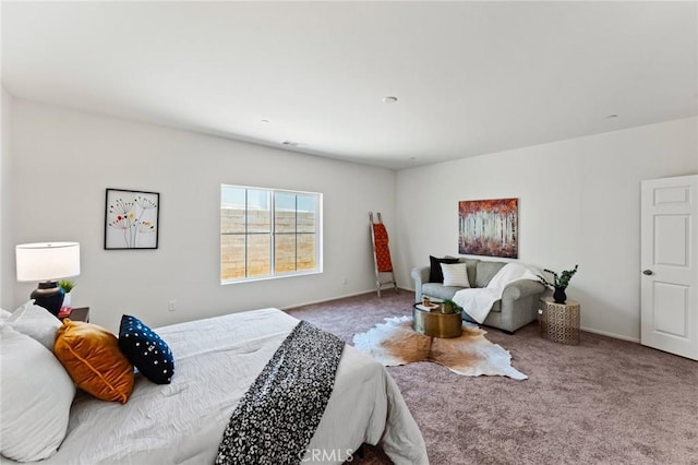 bedroom featuring carpet and baseboards