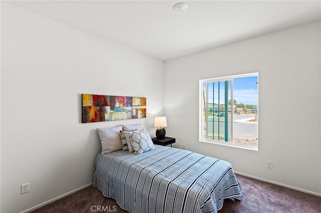 carpeted bedroom with baseboards