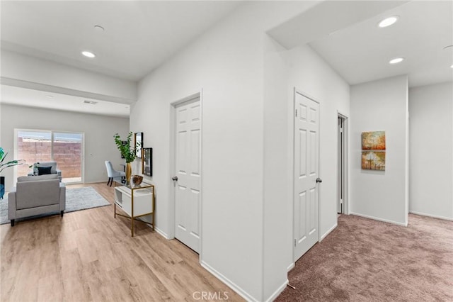 hallway featuring recessed lighting and baseboards