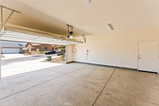 garage featuring baseboards and a garage door opener