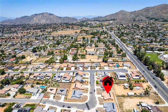 aerial view of property and surrounding area with mountains