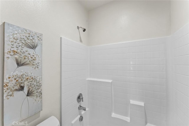 bathroom with toilet and tub / shower combination