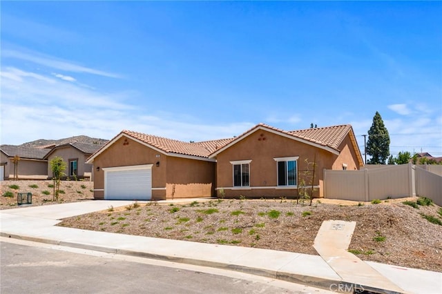 ranch-style house featuring stucco siding, a tiled roof, a garage, and concrete driveway